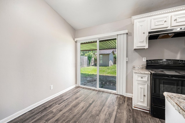 16243 Knollridge Ct, Houston, TX 77053 - kitchen with black range with electric cooktop, under cabinet range hood, dark wood-type flooring, lofted ceiling, and white cabinetry