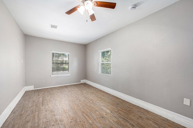 16243 Knollridge Ct, Houston, TX 77053 - spare room featuring a smoke detector, wood finished floors, baseboards, and a ceiling fan