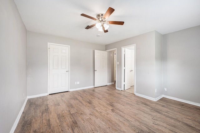 16243 Knollridge Ct, Houston, TX 77053 - unfurnished bedroom featuring baseboards, wood finished floors, and a ceiling fan