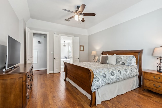 11802 Guernsey Dr, Tomball, TX 77377 - bedroom with wood-type flooring, baseboards, ensuite bath, and ceiling fan