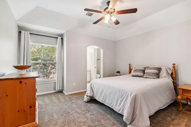 11802 Guernsey Dr, Tomball, TX 77377 - bedroom with carpet flooring, arched walkways, baseboards, connected bathroom, and ceiling fan
