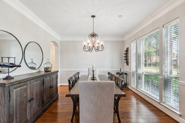 11802 Guernsey Dr, Tomball, TX 77377 - dining space featuring a chandelier, dark wood-type flooring, crown molding, and arched walkways