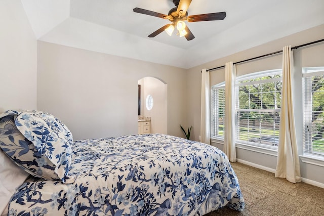11802 Guernsey Dr, Tomball, TX 77377 - bedroom with light carpet, arched walkways, baseboards, and ceiling fan