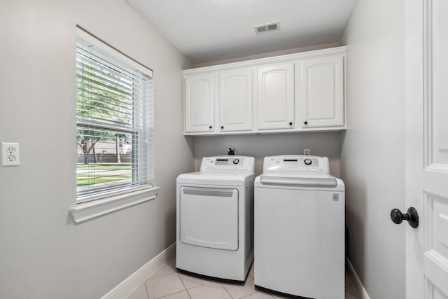 11802 Guernsey Dr, Tomball, TX 77377 - clothes washing area featuring independent washer and dryer, cabinet space, baseboards, and light tile patterned floors