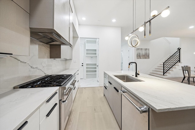 709 Moody St, Houston, TX 77009 - kitchen featuring a sink, appliances with stainless steel finishes, light wood-type flooring, modern cabinets, and recessed lighting
