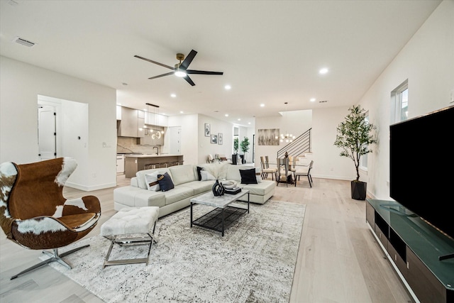 709 Moody St, Houston, TX 77009 - living area featuring light wood-style floors, recessed lighting, a ceiling fan, baseboards, and stairs