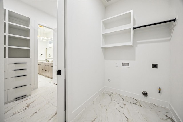 709 Moody St, Houston, TX 77009 - laundry area with hookup for a gas dryer, light marble finish flooring, hookup for an electric dryer, hookup for a washing machine, and baseboards