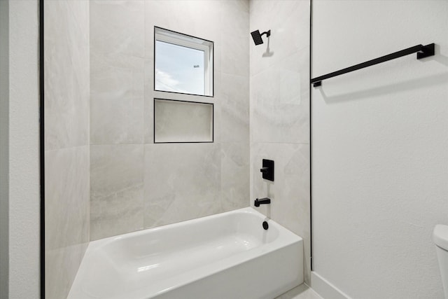 709 Moody St, Houston, TX 77009 - full bathroom featuring toilet, tub / shower combination, and baseboards