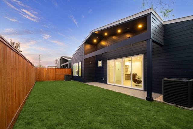 709 Moody St, Houston, TX 77009 - back of property at dusk with cooling unit and a patio