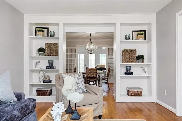 1062 Lamonte Ln, Houston, TX 77018 - living area featuring built in features, a chandelier, wood finished floors, and ornamental molding