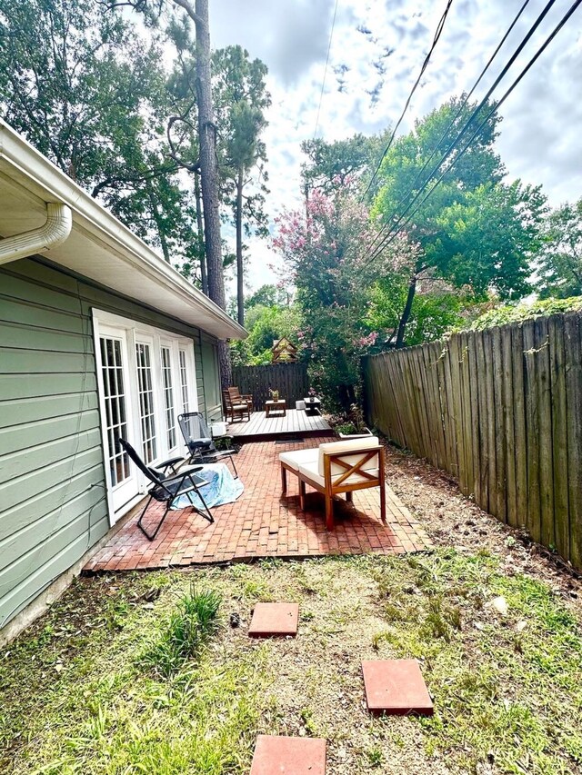 1062 Lamonte Ln, Houston, TX 77018 - fenced backyard featuring a patio area, a wooden deck, and french doors