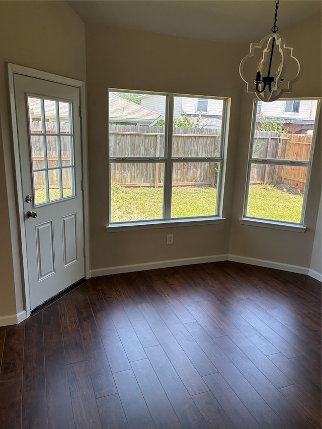 19638 Plantation Grove Trl, Katy, TX 77449 - unfurnished dining area featuring a chandelier, dark wood-style floors, and baseboards