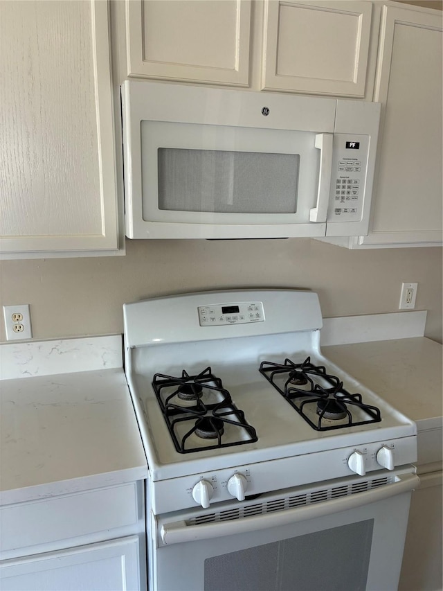 19638 Plantation Grove Trl, Katy, TX 77449 - kitchen with white appliances, light countertops, and white cabinetry
