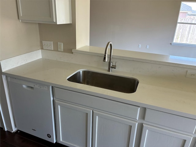 19638 Plantation Grove Trl, Katy, TX 77449 - kitchen with white dishwasher, a sink, and light stone countertops