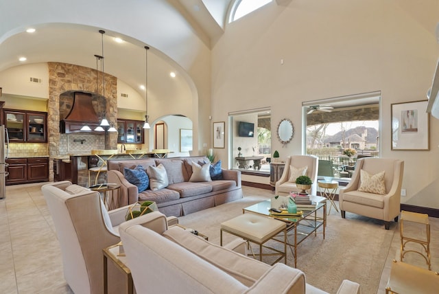 14 Royal King Rd, Tomball, TX 77377 - living room with arched walkways, high vaulted ceiling, a ceiling fan, and baseboards