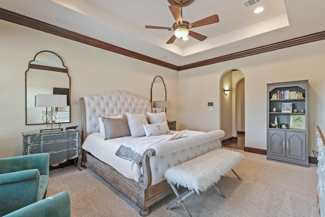 14 Royal King Rd, Tomball, TX 77377 - carpeted bedroom featuring arched walkways, a tray ceiling, crown molding, and a ceiling fan