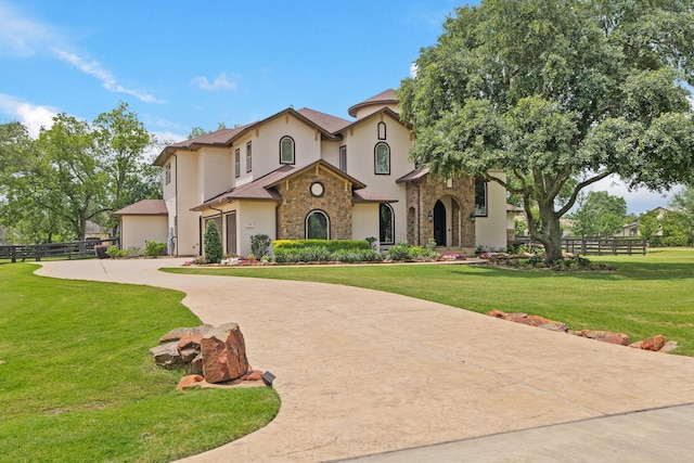 14 Royal King Rd, Tomball, TX 77377 - mediterranean / spanish-style home with stone siding, stucco siding, and curved driveway