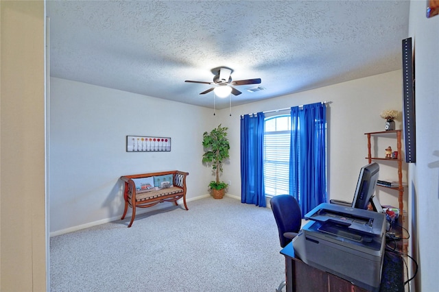 carpeted office with a ceiling fan, a textured ceiling, and baseboards