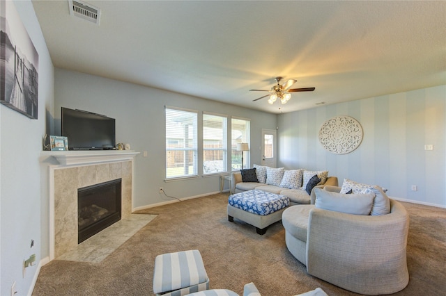 living room with carpet, ceiling fan, baseboards, and a premium fireplace