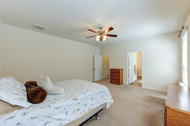 bedroom with light colored carpet, baseboards, and ceiling fan