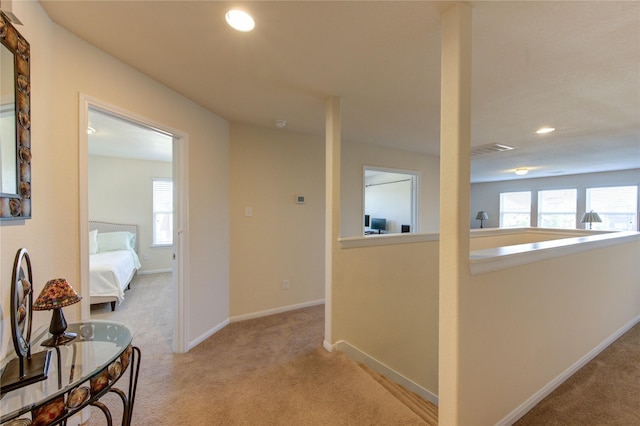 corridor featuring carpet floors, healthy amount of natural light, recessed lighting, and baseboards