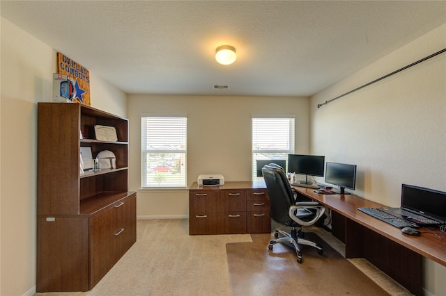 home office featuring light carpet and baseboards