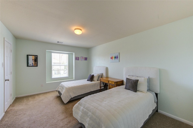 bedroom featuring carpet floors and baseboards