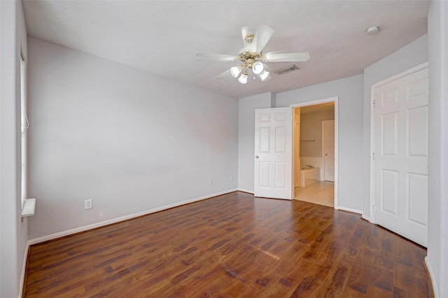 2710 Grants Lake Blvd Unit L8, Sugar Land, TX 77479 - unfurnished bedroom featuring baseboards, wood finished floors, and ceiling fan