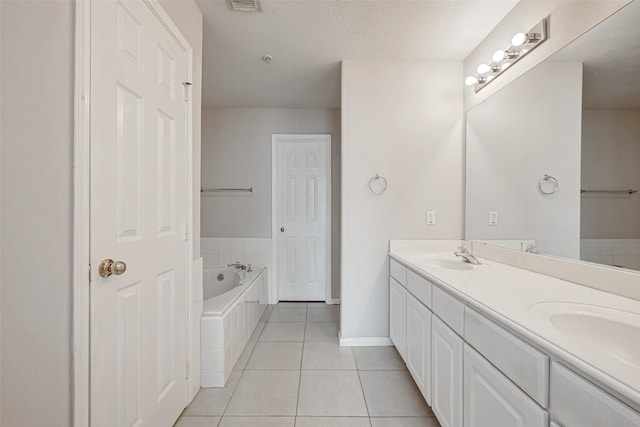 2710 Grants Lake Blvd Unit L8, Sugar Land, TX 77479 - bathroom featuring tile patterned flooring, double vanity, a garden tub, and baseboards
