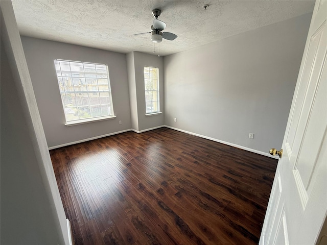 2710 Grants Lake Blvd Unit L8, Sugar Land, TX 77479 - empty room with dark wood finished floors, a textured ceiling, baseboards, and ceiling fan