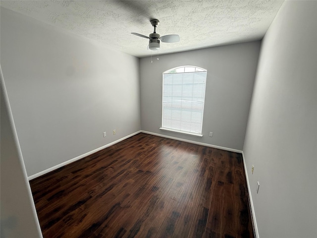 2710 Grants Lake Blvd Unit L8, Sugar Land, TX 77479 - unfurnished room featuring dark wood-style floors, a ceiling fan, baseboards, and a textured ceiling