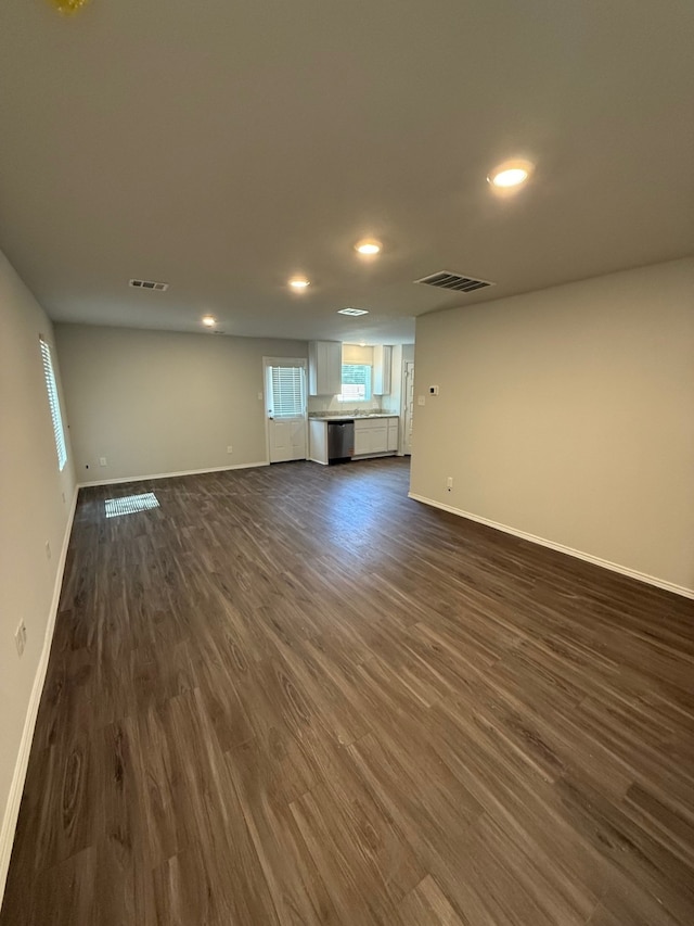 22711 American Kestrel Ct, Splendora, TX 77372 - unfurnished living room featuring recessed lighting, baseboards, and dark wood finished floors