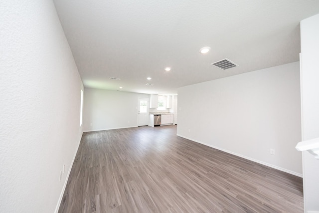 22711 American Kestrel Ct, Splendora, TX 77372 - unfurnished living room featuring recessed lighting and wood finished floors