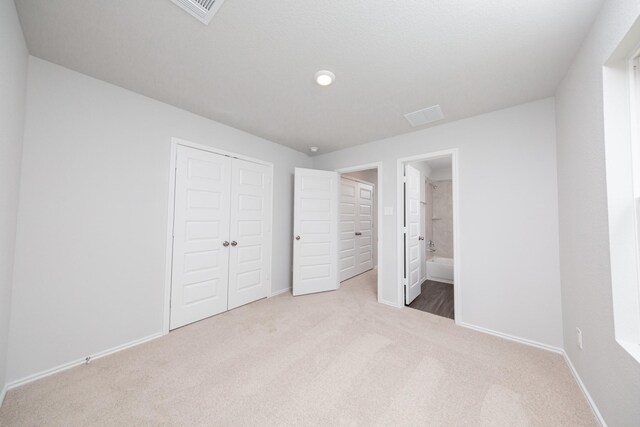 22711 American Kestrel Ct, Splendora, TX 77372 - unfurnished bedroom featuring carpet, a closet, recessed lighting, and connected bathroom