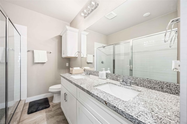 5023 Mallow St A/B, Unit A/B Houston, TX 77033 - bathroom featuring a stall shower, toilet, baseboards, and double vanity