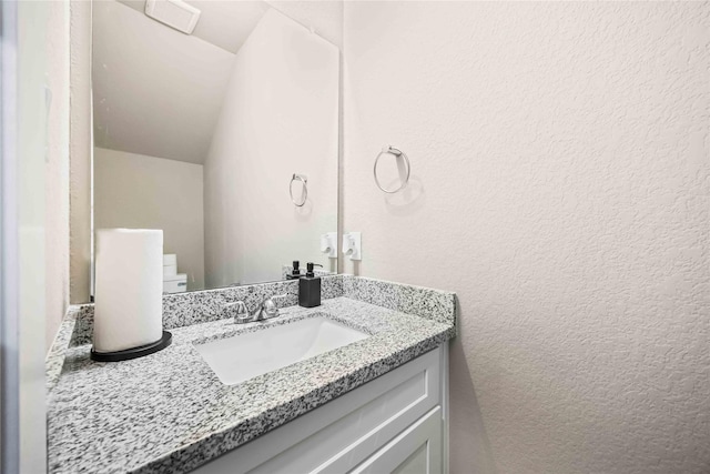 5023 Mallow St A/B, Unit A/B Houston, TX 77033 - bathroom featuring a textured wall and vanity