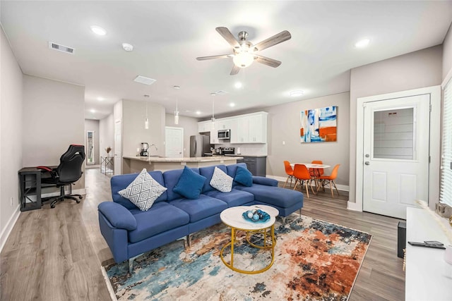 5023 Mallow St A/B, Unit A/B Houston, TX 77033 - living area with baseboards, a ceiling fan, light wood-type flooring, and recessed lighting