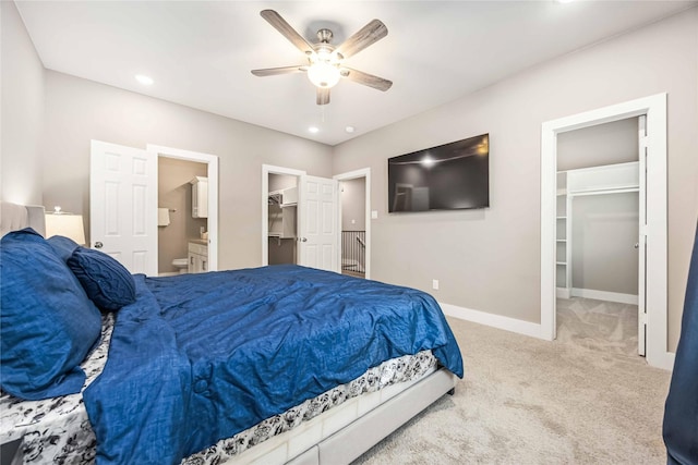 5023 Mallow St A/B, Unit A/B Houston, TX 77033 - carpeted bedroom featuring a walk in closet, a closet, connected bathroom, baseboards, and ceiling fan