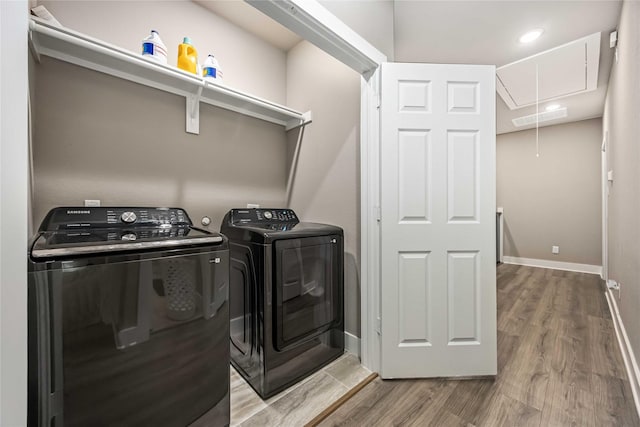 5023 Mallow St A/B, Unit A/B Houston, TX 77033 - laundry area with attic access, washing machine and clothes dryer, wood finished floors, and baseboards