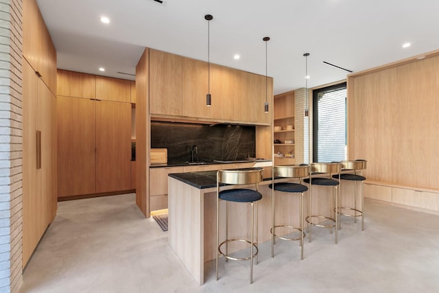 2021 Albans Rd, Houston, TX 77005 - kitchen featuring finished concrete flooring, a breakfast bar area, modern cabinets, dark countertops, and recessed lighting