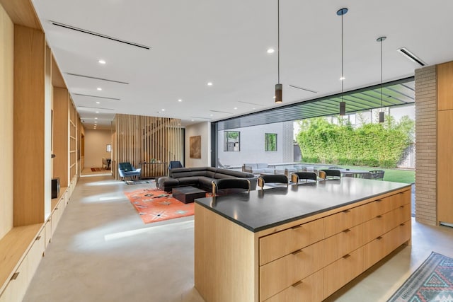 2021 Albans Rd, Houston, TX 77005 - kitchen featuring concrete flooring, modern cabinets, light brown cabinets, a center island, and recessed lighting