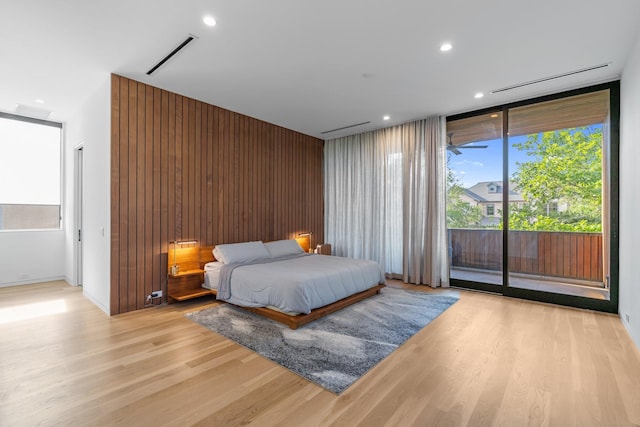 2021 Albans Rd, Houston, TX 77005 - bedroom featuring access to exterior, light wood-type flooring, multiple windows, recessed lighting, and wooden walls