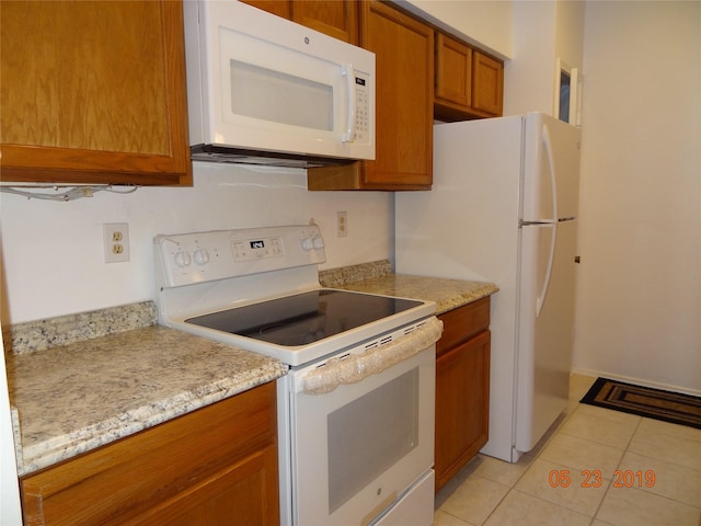 434 Wilcrest Dr Unit 434, Houston, TX 77042 - kitchen featuring white appliances, brown cabinetry, and light tile patterned flooring