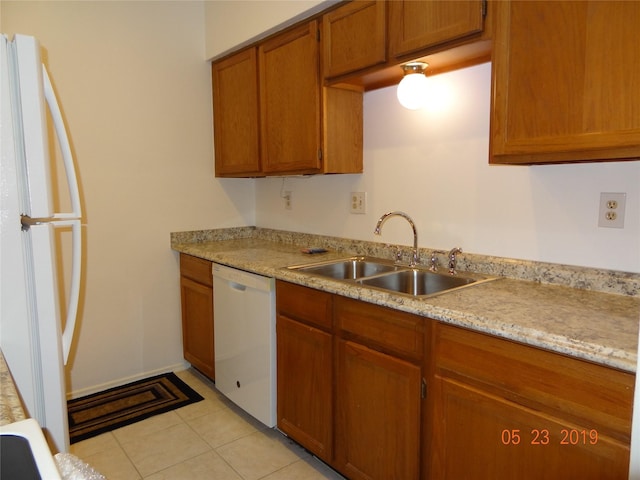 434 Wilcrest Dr Unit 434, Houston, TX 77042 - kitchen with white appliances, a sink, light countertops, brown cabinetry, and light tile patterned floors