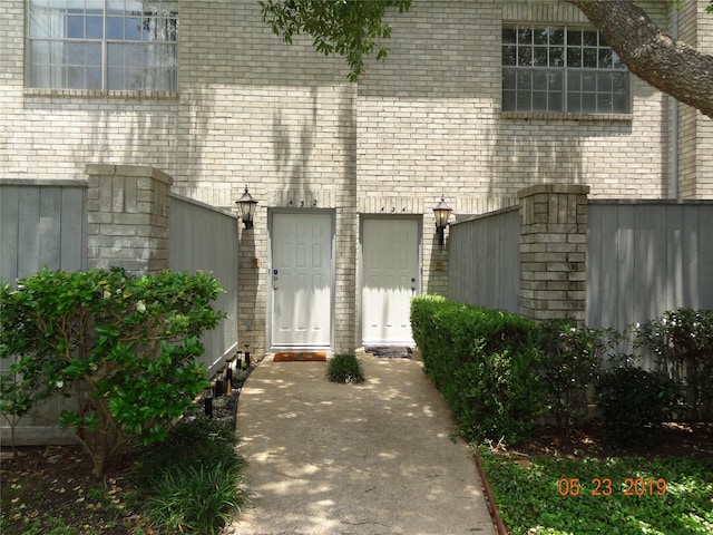 434 Wilcrest Dr Unit 434, Houston, TX 77042 - doorway to property with brick siding and fence