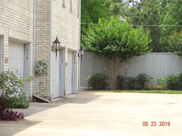 434 Wilcrest Dr Unit 434, Houston, TX 77042 - view of patio featuring fence and a garage