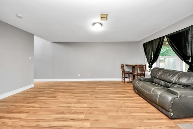 living room featuring light wood finished floors and baseboards