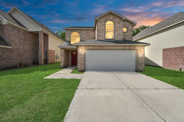 traditional-style home featuring concrete driveway, a front lawn, brick siding, and an attached garage