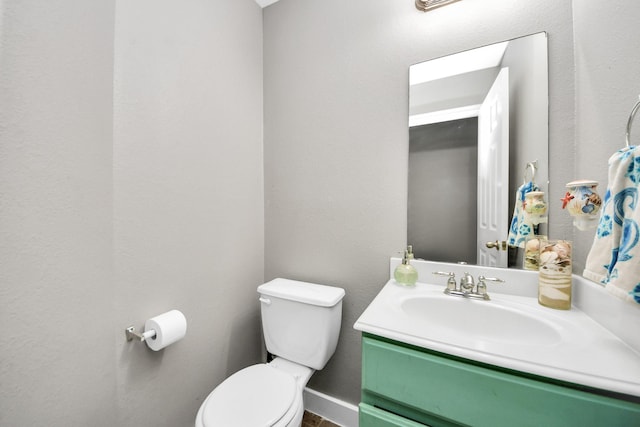 bathroom featuring toilet and vanity