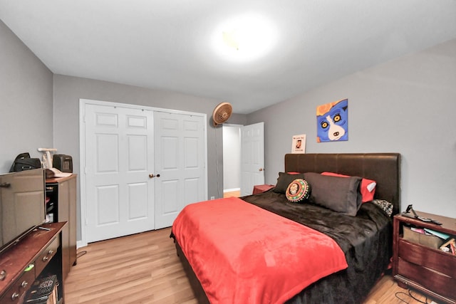 bedroom with light wood-type flooring and a closet